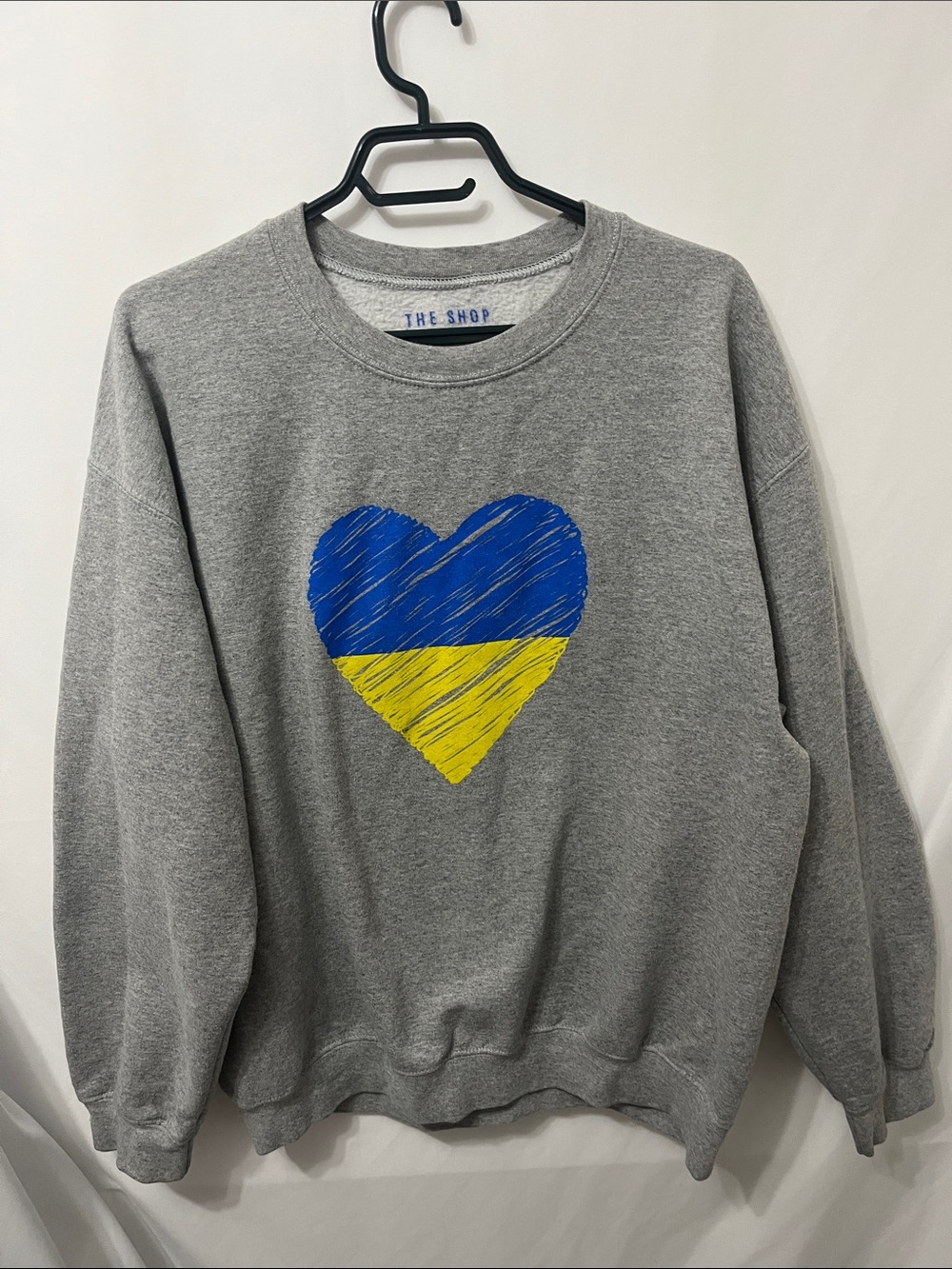 USA Made The Shop Forward Gray Sweatshirt with Blue and Yellow Heart Graphic